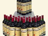 bottles of red wine are stacked on top of each other