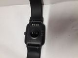 a close up of a black watch on a white surface