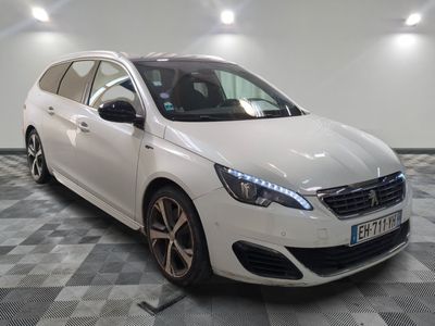 the white car is parked on a checkered floor in the garage