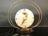 a clock that is sitting on a table with a chain around it