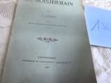 un vieux livre posé sur une table, à côté d'un verre de vin
