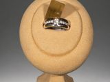 yellow stone ring holder with a diamond ring on top of it