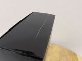 a black box sitting on top of a wooden table
