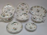 many different types of porcelain dishes and bowls on the table