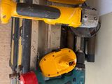 two electric tools are sitting on a shelf next to a window
