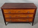 a wooden chest of drawers with three drawers on each side