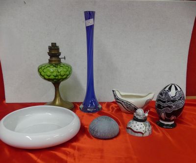 a table with a bowl, vase, and other items on it