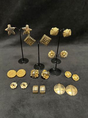 a collection of gold and silver earrings and brooches
