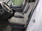 the interior of a white van with grey seats and a steering wheel
