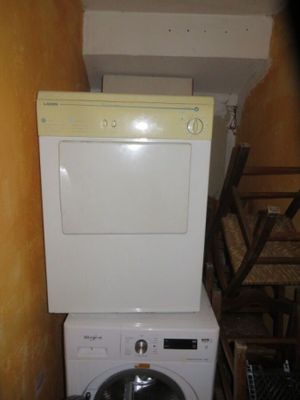 a white washer and dryer in a small room