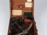an old wooden box with a sexet and other items in it