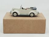 a white toy car sitting on top of a cardboard box