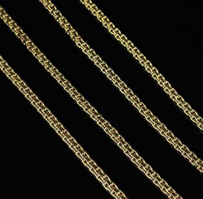 a close up of a gold chain on a black background