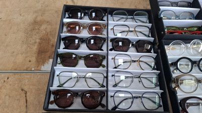 many pairs of glasses sitting in a box on the floor