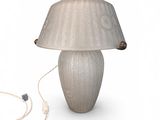 une lampe posée sur une table à côté d'un cordon