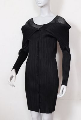 the mannequin is wearing a black dress with sheer shoulders