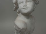 statue of a young girl with curly hair wearing a dress