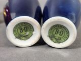 pair of blue and white vases with a green label on them