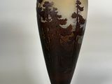 a vase that has a picture of a forest on it