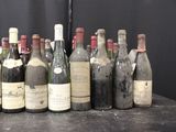 bottles of wine are lined up on a table in front of a black backdrop