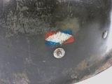 a close up of a helmet with a red, white, and blue sticker on it