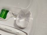 a toothbrush and a toothpaste holder on a table