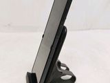 a cell phone that is on a stand on the table