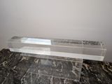 a glass shelf on a marble floor in a room