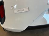 a close up of a white car with a measuring tape on it