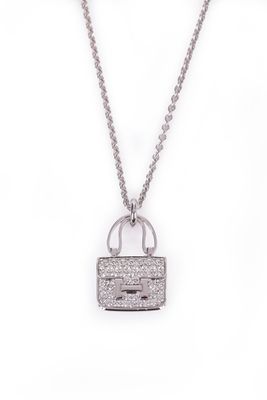 a white gold necklace with a lock and chain on a white background