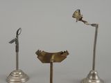 four different types of metal objects are displayed on a white surface