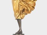 an image of a bronze statue of a woman holding a fan