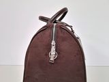a close up of a brown handbag on a white surface