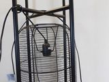 a fan that is sitting on a stand next to a chair