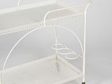 white metal serving cart with two wheels and a basket on top of it