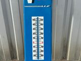 a blue thermometer that is on the ground