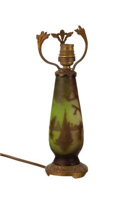 a lamp that is sitting on a stand with a light on it