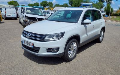 the white volkswagen tigua is parked in the parking lot