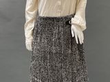 an image of a mannequin wearing a white shirt and black and white skirt
