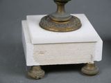 a small vase sitting on top of a white box