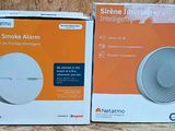 two boxes of a smart smoke alarm sitting on a table