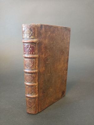 a book that is sitting on a table next to a cup