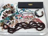 a tray that has many different types of jewelry on it