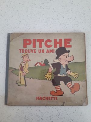 un livre sur lequel figure un personnage de bande dessinée, posé sur une table