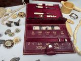 a red case that has a lot of jewelry in it