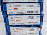 four boxes of blue and white tickets sitting on top of each other