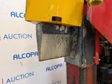 a close up of a yellow and red object on a machine