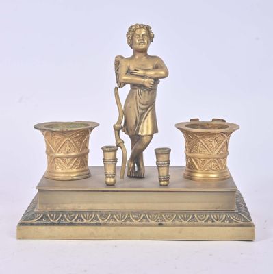 brass figurine of a boy with a bucket and two vases