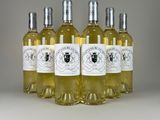 four bottles of white wine sitting on top of a table