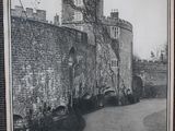 a black and white photo of a castle with a clock